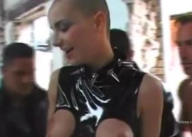 Shaved young slut in latex is banged by two cocks